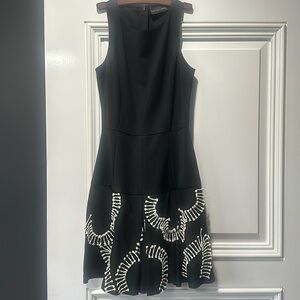 Sachin and Babi black sleeveless round neck dress with white bottom details.